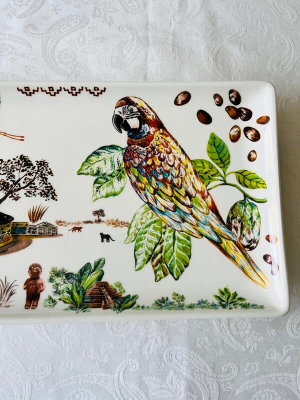 Detail van het Gien Cacao decor: exotisch landschap met flamingo, traditionele hut, cacaovruchten en een kleurrijke papegaai.